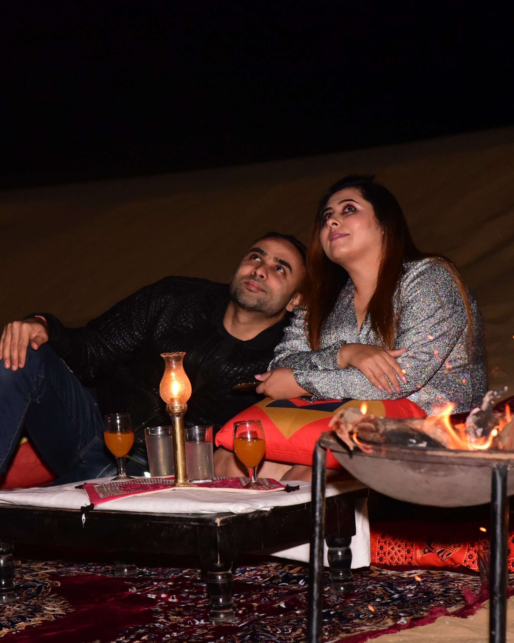 beautiful couple enjoying the millions of start in the heart of thar desert